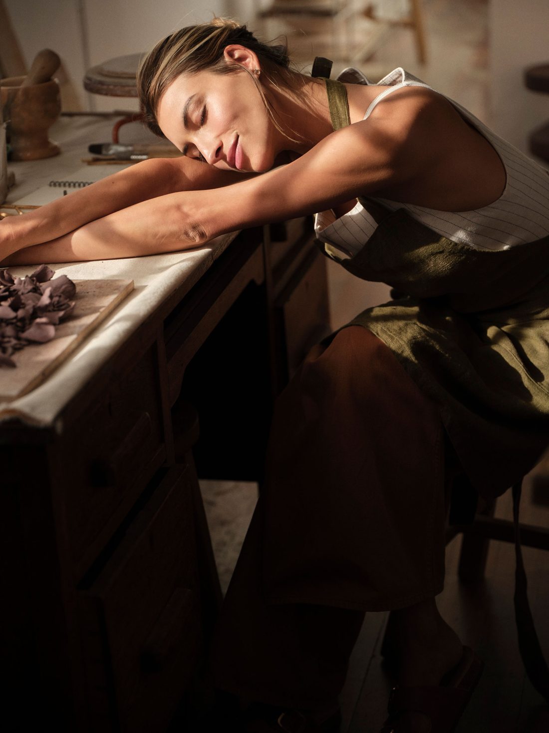 Woman resting at a workbench
